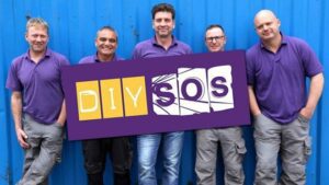 The DIY SOS team holding up a sign