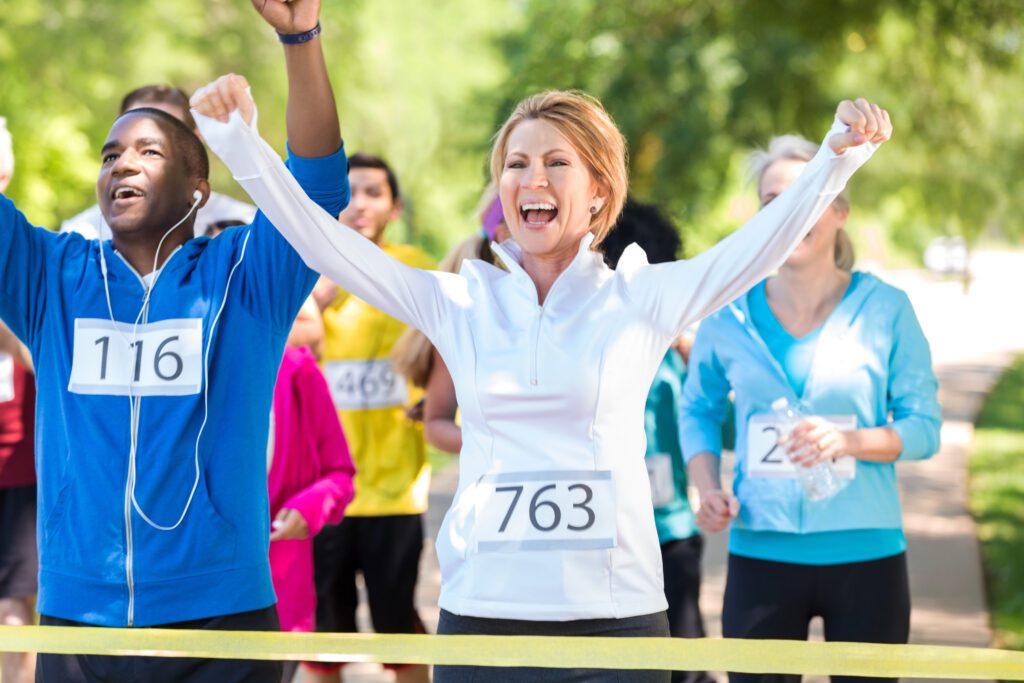 Happy runners celebrating as they win marathon or 5k race